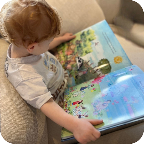 Child reading Starlight Helps the World hardcover book — Stories with Starlight